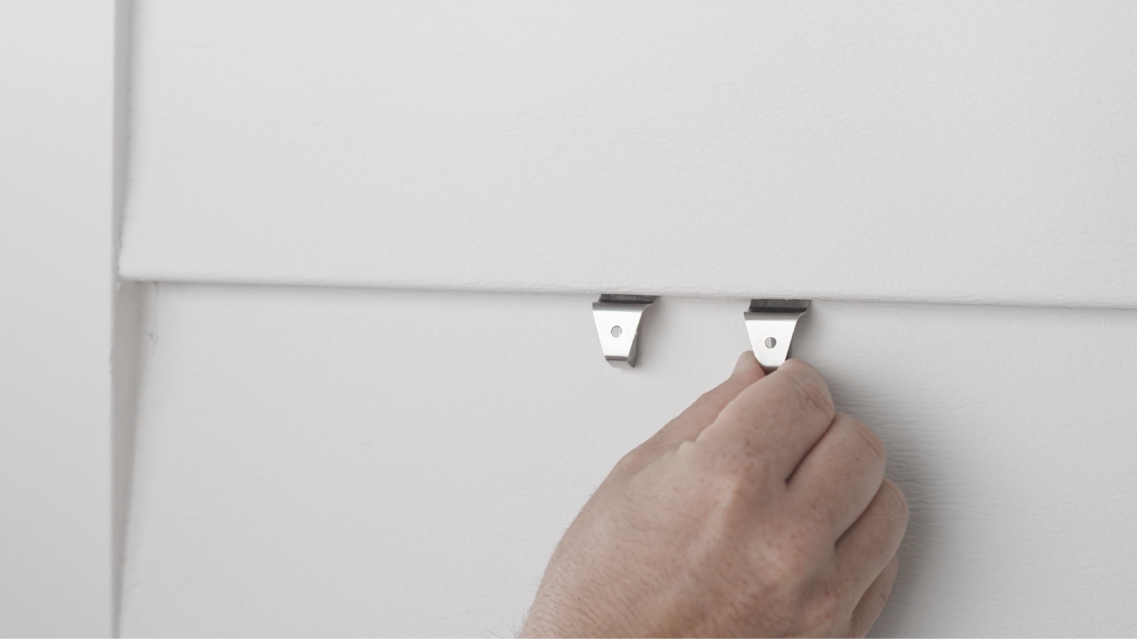 vinyl siding clips shown at joint between siding panels