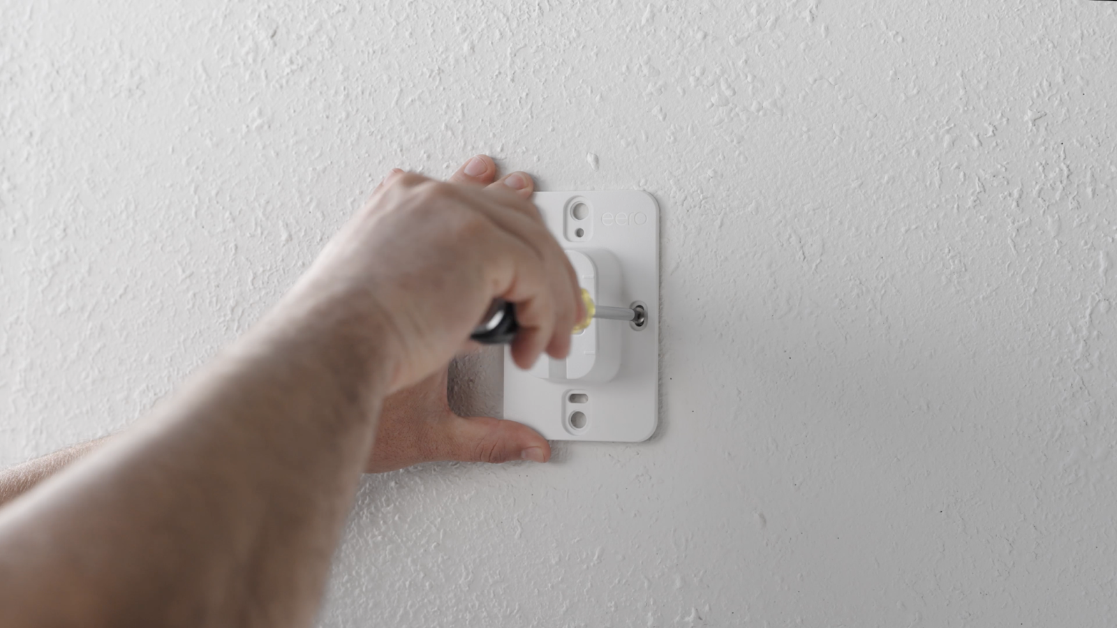 attaching mounting bracket to wall with screws